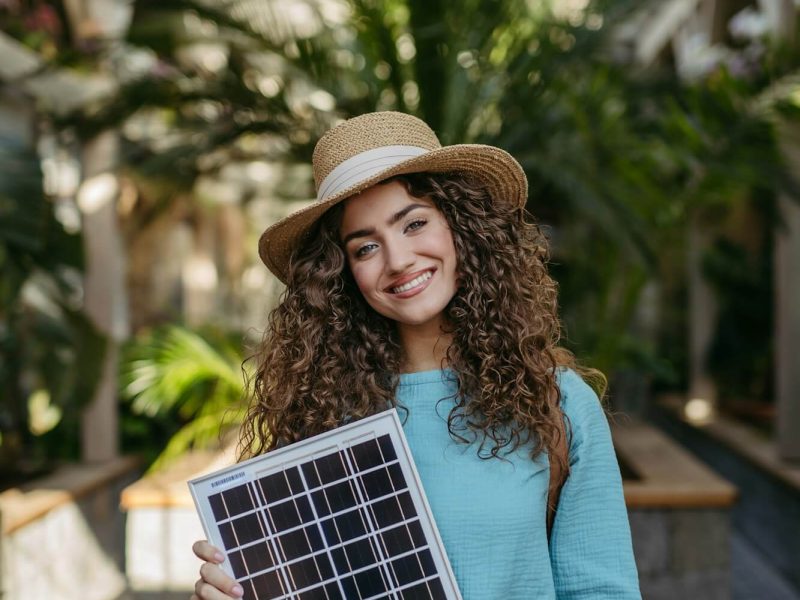 young-woman-in-botanical-garden-holding-solar-panel-concept-of-green-energy-.jpg
